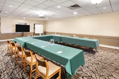 a conference room with a long table and chairs at Days Inn by Wyndham Nanaimo in Nanaimo