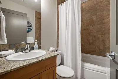 a bathroom with a sink and a toilet and a shower at RidgeView Loft - Top Floor 2 Bed 2 Bath, Amazing Views in Canmore