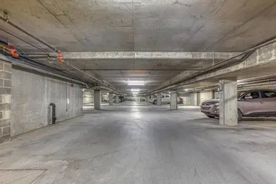 an empty parking garage with cars parked in it at RidgeView Loft - Top Floor 2 Bed 2 Bath, Amazing Views in Canmore