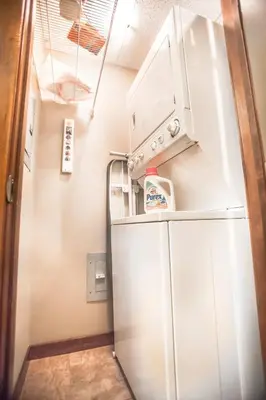 a kitchen with a refrigerator with a microwave above it at RidgeView Loft - Top Floor 2 Bed 2 Bath, Amazing Views in Canmore