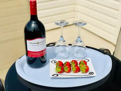 a bottle of wine and two wine glasses on a table at Country View Motor Inn in Kamloops