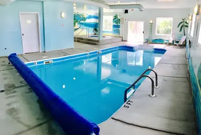 a large swimming pool with a blue water slide at Country View Motor Inn in Kamloops