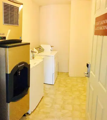 a room with a kitchen with a phone in it at Country View Motor Inn in Kamloops