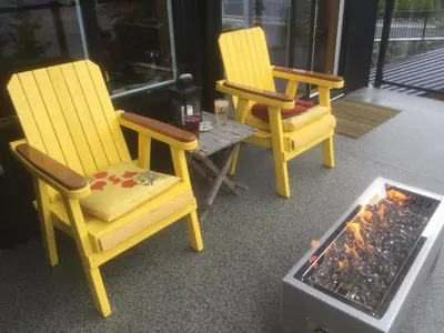 two chairs and a table with a fire place at Bjørn Holm in Port Renfrew