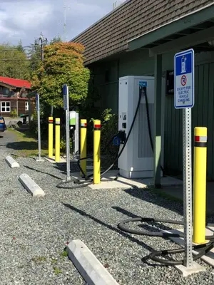 a row of yellow poles in front of a building at Bjørn Holm in Port Renfrew