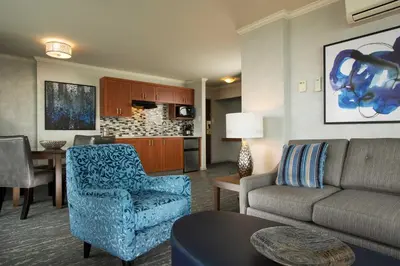 a living room with a couch and a table at Chateau Victoria Hotel & Suites in Victoria