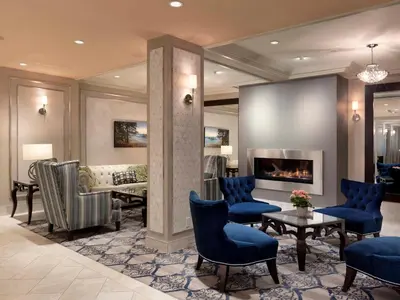a lobby with a living room with a fireplace at Chateau Victoria Hotel & Suites in Victoria