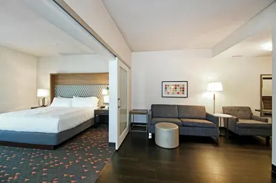 a hotel room with a bed and a couch at Holiday Inn Hotel & Suites - Calgary Airport North by IHG in Calgary