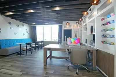 a office with a table and chairs in a room at Holiday Inn Hotel & Suites - Calgary Airport North by IHG in Calgary