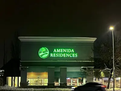 a amandaresurance building with a car in front of it at Amenida Residences, Calgary in Calgary