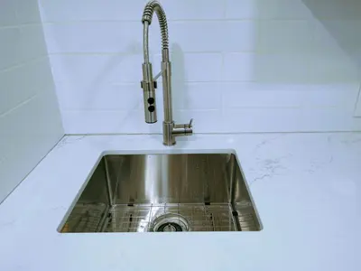 a stainless steel sink in a white counter top at U of A Homestay, Trails & Whyte Ave in Edmonton