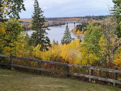 a view of a river from a wooden fence at U of A Homestay, Trails & Whyte Ave in Edmonton