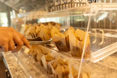 a person is reaching for a tray of food at Inn on Long Lake in Nanaimo