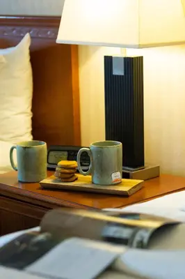 two coffee mugs on a tray on a table at Inn on Long Lake in Nanaimo