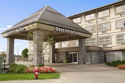 a building with a sign for days inn and suites at Days Inn & Suites by Wyndham Langley in Langley