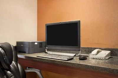 a desk with a computer and a printer on it at Days Inn & Suites by Wyndham Langley in Langley