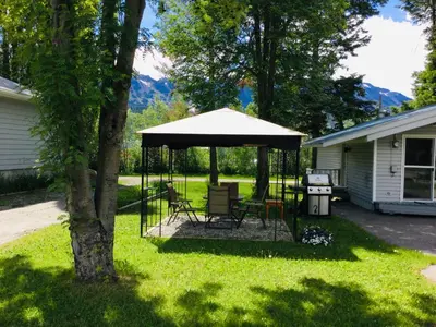 a gazebo with a table and chairs in a yard at Brookside Motel in Golden