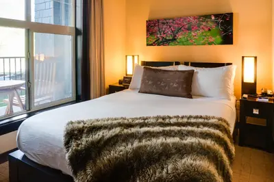 a bedroom with a large bed and a window at Silver Creek Lodge in Canmore