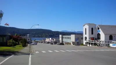 an empty street in a small town with a church at Char's Landing Hostel in Port Alberni