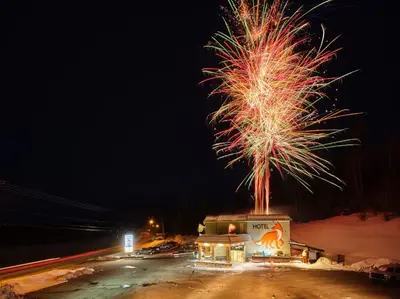 a firework display in a parking lot at night at Fernie Fox Hotel in Fernie