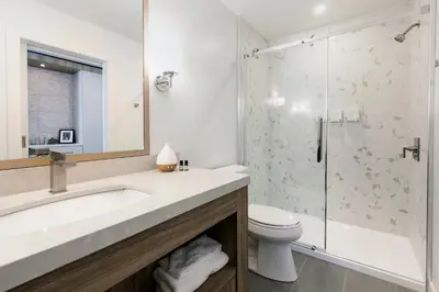 a bathroom with a sink and a toilet and a shower at Glacier View Lodge in Sunwapta