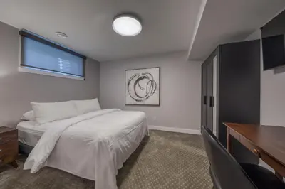 a bedroom with a bed and a flat screen tv at Bighorn Meadows Resort in Radium Hot Springs