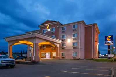 a hotel with a parking lot in front of it at Comfort Inn & Suites in Edson