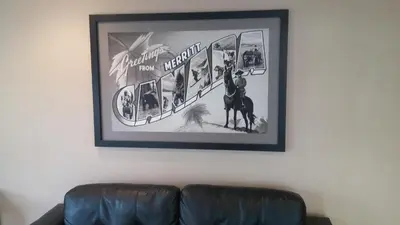 a picture hanging on a wall above a couch at Sage Inn Merritt BC in Merritt
