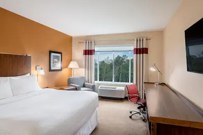 a hotel room with a bed and a desk at Four Points by Sheraton Grande Prairie in Grande Prairie