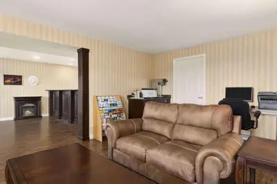 a living room with a couch and a fireplace at Travelodge by Wyndham Kamloops Mountview in Kamloops