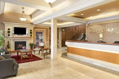 a lobby of a hotel with a fireplace at Travelodge by Wyndham Edmonton East in Edmonton