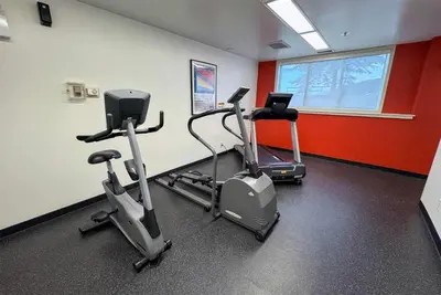 a gym with two exercise bikes in a room at Ramada by Wyndham Sherwood Park in Sherwood Park