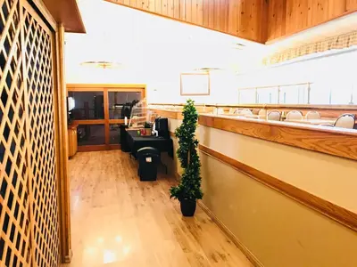 a lobby with a waiting room with a potted plant at Northern Star Hotel & Convention Center in Slave Lake