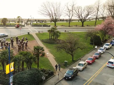 a view of a city with cars parked in a park at English Bay Hotel in Vancouver