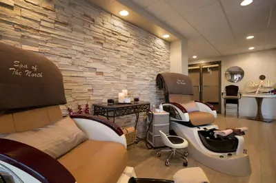 a salon with a barber shop with a rock wall at Coast Prince George Hotel by APA in Prince George