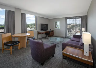 a living room with a couch and a table at Coast Prince George Hotel by APA in Prince George