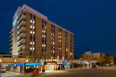a large hotel building on a city street at night at Coast Prince George Hotel by APA in Prince George