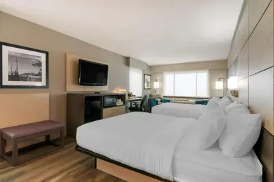 a hotel room with a bed and a television at Best Western Premier Aberdeen Kamloops in Kamloops
