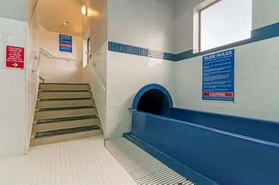a staircase in a gym with blue and white walls at Best Western Premier Aberdeen Kamloops in Kamloops
