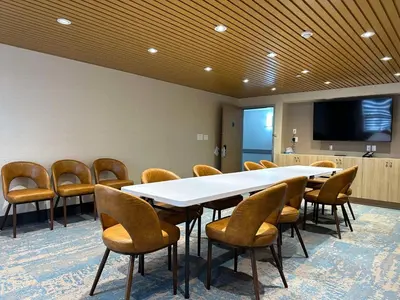 a conference room with a large table and chairs at SureStay Plus by Best Western Brooks in Brooks