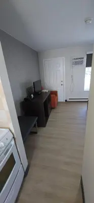 an empty room with a kitchen and a living room at Riverside Motel in Penticton