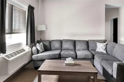a living room with a couch and a table at SureStay Studio by Best Western Hardisty in Hardisty