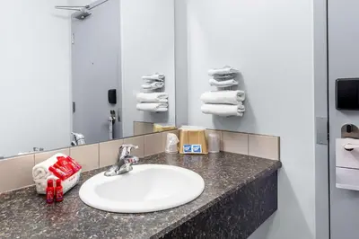 a bathroom with a sink and a mirror at SureStay Studio by Best Western Hardisty in Hardisty