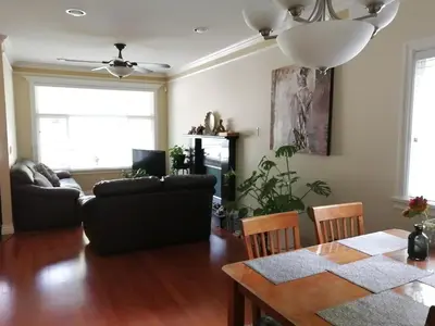a living room with a table and a couch at Three Kittens Guesthouse in Burnaby