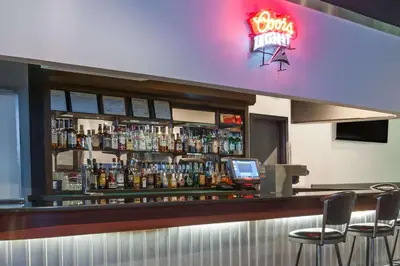 a bar with a lot of bottles of alcohol at Super 8 by Wyndham Edmonton/West in Edmonton