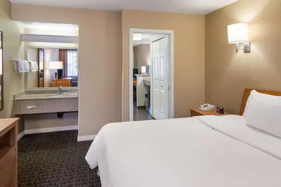 a hotel room with a bed and a bathroom at SureStay by Best Western North Vancouver Capilano in North Vancouver