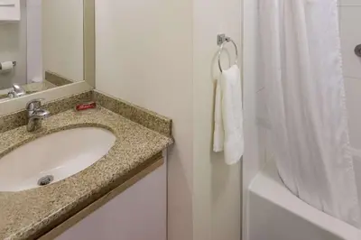 a bathroom with a sink and a shower at SureStay by Best Western North Vancouver Capilano in North Vancouver