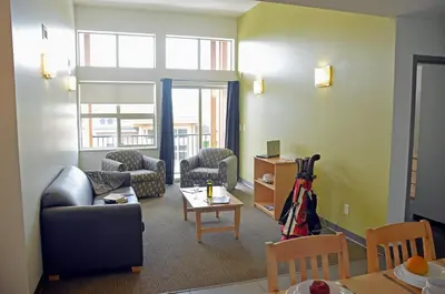 a living room with a couch and chairs and a table at UBC Okanagan Campus in Kelowna