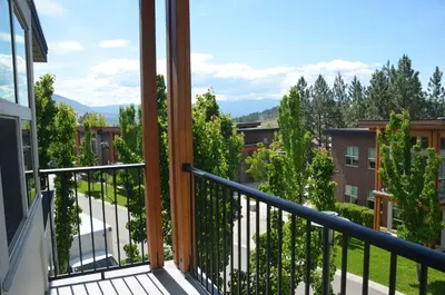 a balcony with a view of trees and buildings at UBC Okanagan Campus in Kelowna