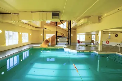 a large swimming pool in a building at Ramada by Wyndham Cranbrook in Cranbrook